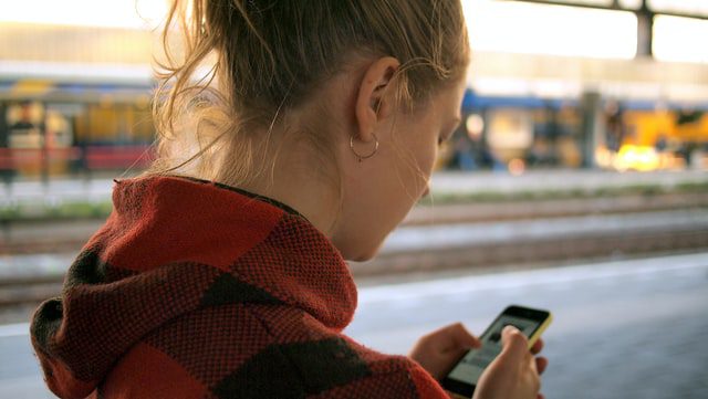 woman holding phone | health information