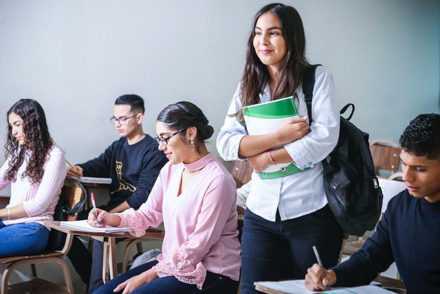 woman in school holding books | innovation