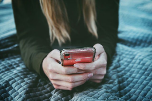 girl holding phone | social media