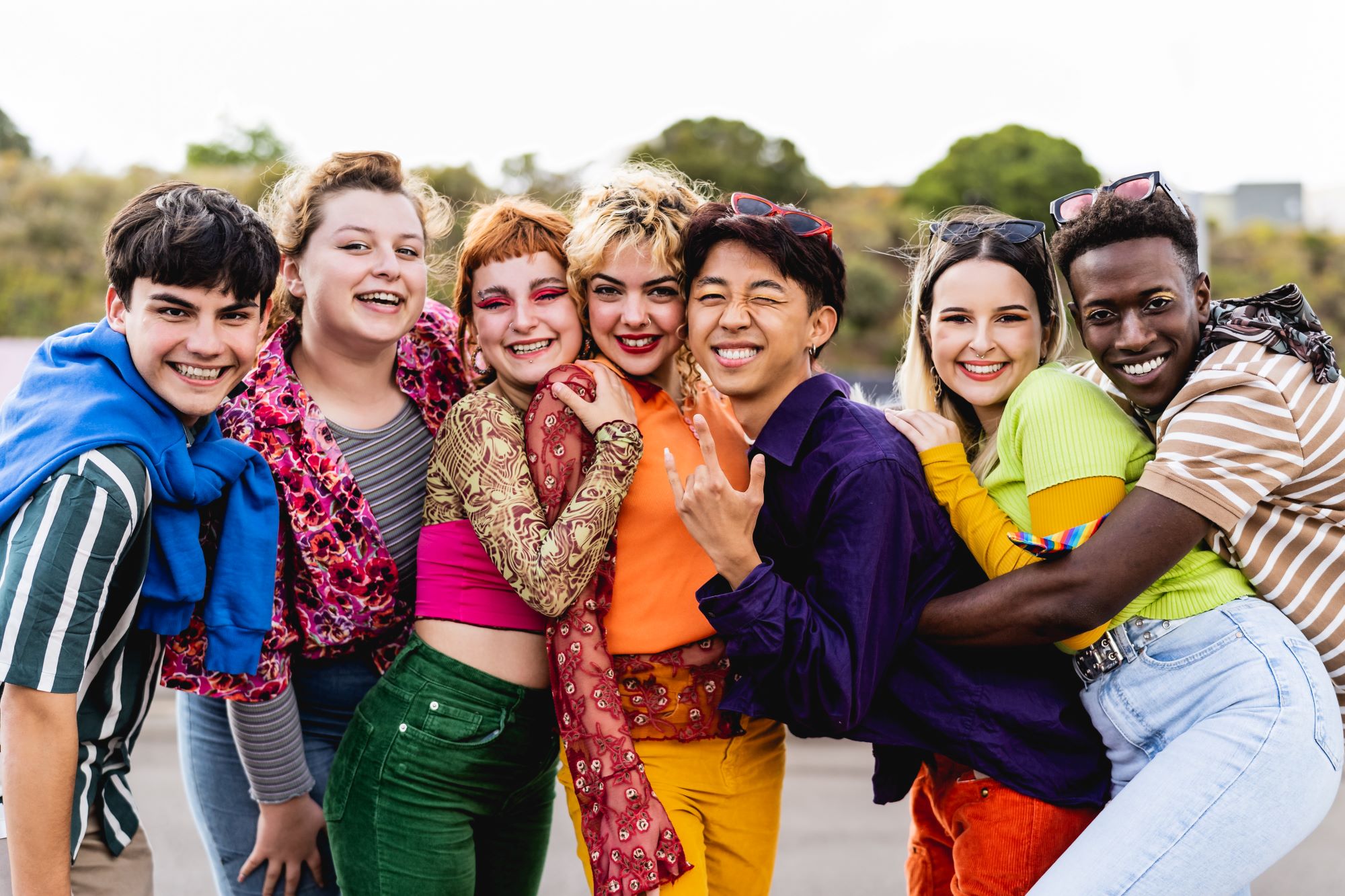 Happy young diverse friends having fun hanging out together