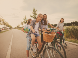 Group-of-teens-riding-bikes-on-a-path-300x225