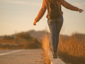 Student-balance-on-a-curb-next-to-a-paved-road-300x225