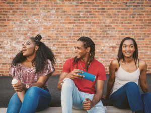 youth-sitting-next-to-a-brick-wall-300x225