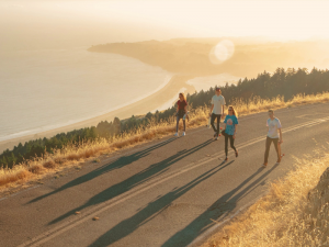 youth-walking-on-a-paved-road-near-the-coast-300x225