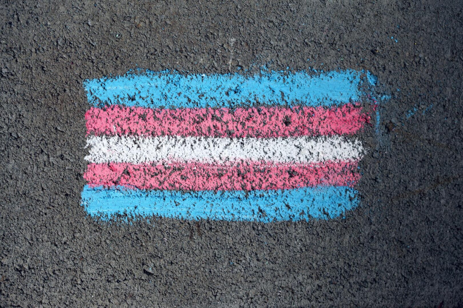 Trans Pride Flag drawn in chalk on the pavement