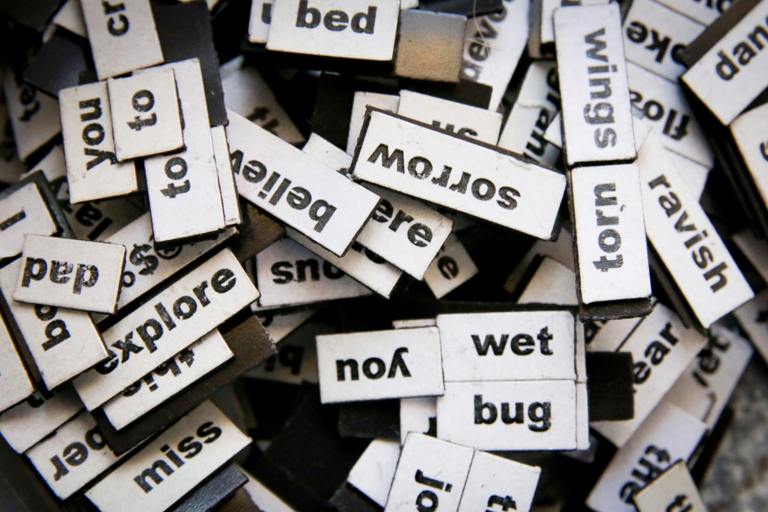 A pile of magnetic tiles, each featuring a different random word