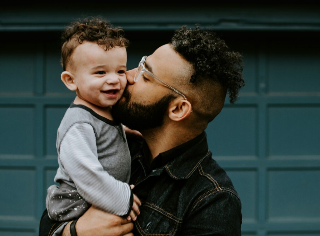 A father holding his toddler son