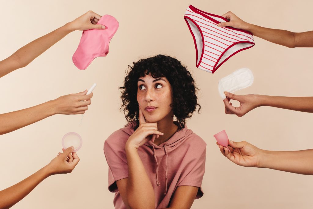 woman contemplating period product options